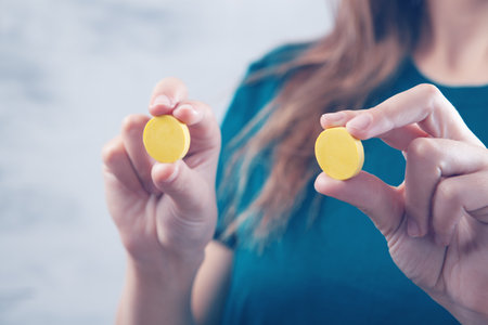 woman holding big yellow pillsの写真素材