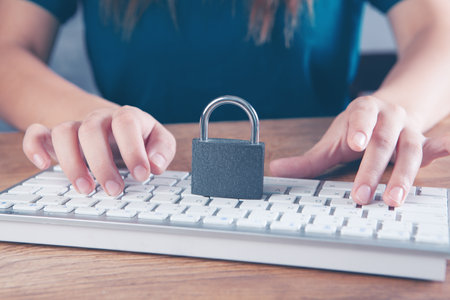 woman typing on the keyboard on which the lock