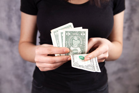 young girl counting dollar bills