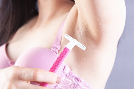 woman in bras shaves her armpit with a razorの写真素材