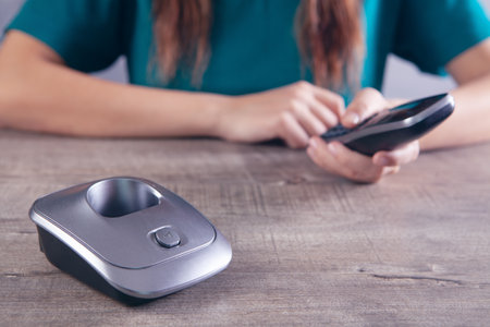 woman dials the number on home phone