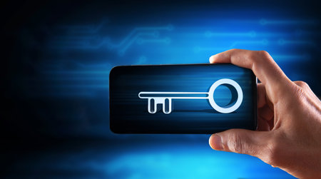 holds the key in the phone on the background of the boardの写真素材