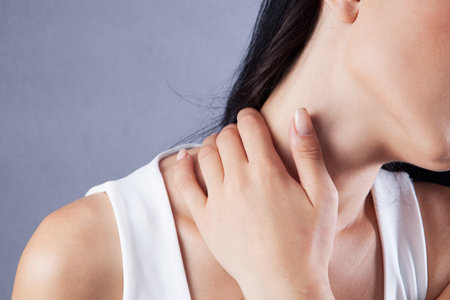 a young girl has a neck acheの写真素材