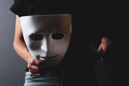 woman in the dark holding a knife and anonymous maskの写真素材