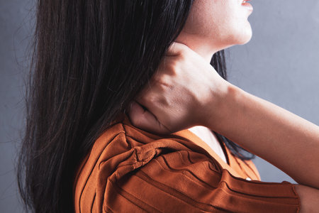a young girl has a neck acheの写真素材
