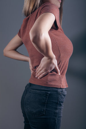 a young girl's back hurts.の写真素材