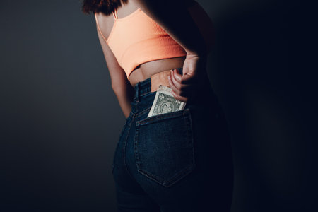 young girl puts money in her pocket