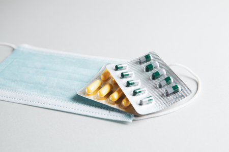 medical mask and capsules on the tableの写真素材