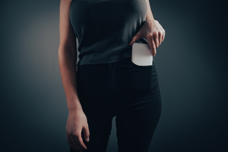 the woman takes the phone out of her pocketの写真素材
