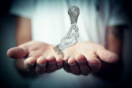 drawn hand holding a lightbulb. man holding open palmsの写真素材