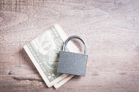 Padlock on the dollar bills. close up. business concept.