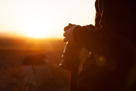 photographer photographs the sunset on the mountains