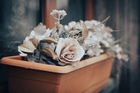 pot of flowers by the window on the house