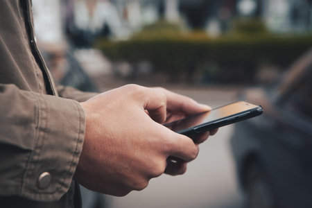 a man stands on the street and uses the phone