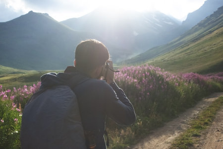 the photographer on the mountain takes a photo