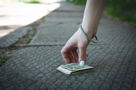 young woman picks up her money