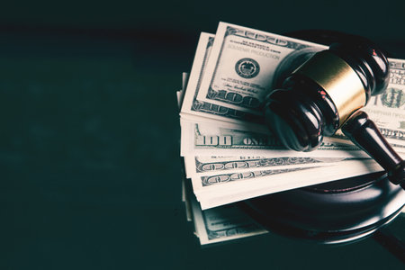 judge's hammer and money on the tableの写真素材