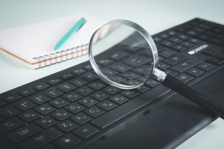 Internet search concept, magnifier and computer keyboard