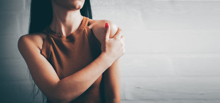 young woman has shoulder painの写真素材