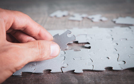 White puzzle pieces on the tableの写真素材
