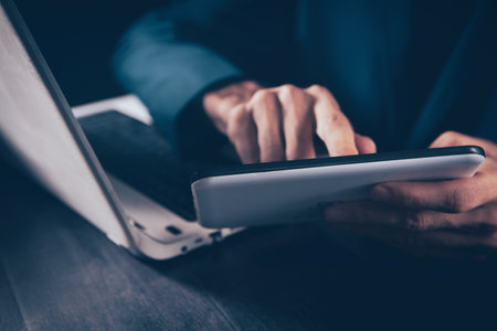 Businessman hand using digital tablet in office meeting roomの写真素材