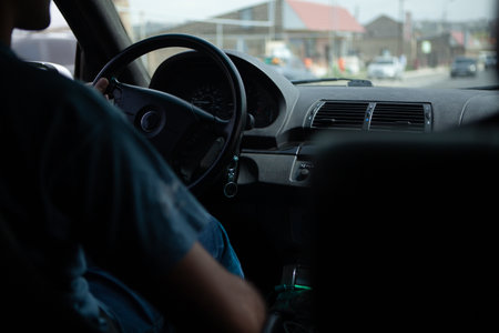 young man drives a car.