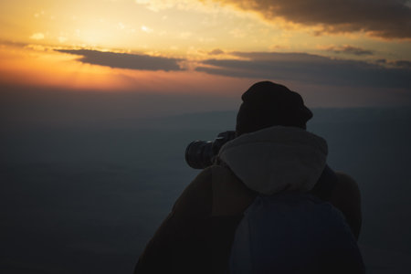 the photographer photographs the sunset in the eveningの写真素材