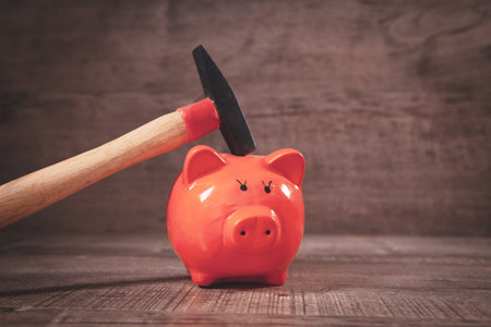 hammer and piggy bank on the tableの写真素材