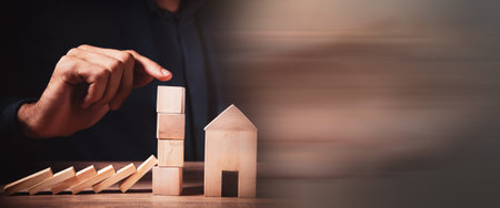 hand stopping risk the wooden blocks from falling on house