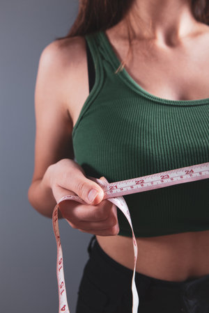 young girl measures her breasts