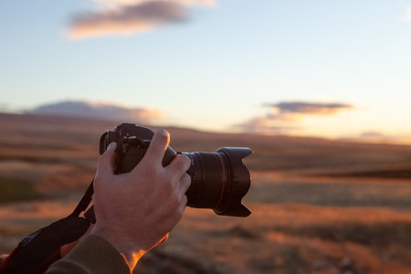 photographer photographs the sunset on the mountainsの写真素材