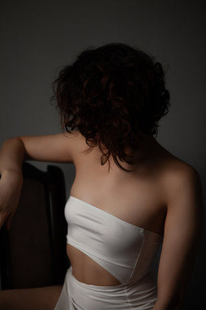 beautiful brunette woman in white underwear posing in studioの写真素材