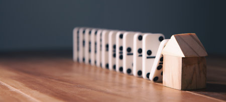 wooden house blocks on black wooden background. business and finance concept.の写真素材