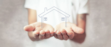 concept of the house. the man holding the houseの写真素材