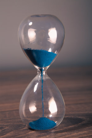 hourglass on a black background with a sand