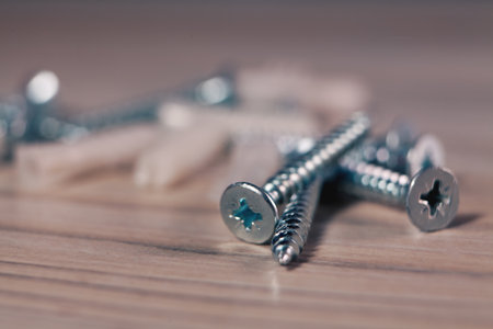 screw, screws on a wooden backgroundの写真素材