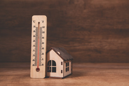 small house with thermometer on table