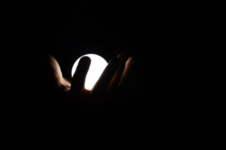hand of a man in a black dress with a black background