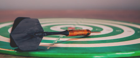 dart board with target on wooden tableの写真素材
