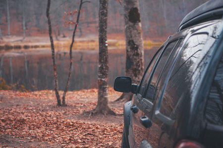 suv with a car. autumn in the mountainsの写真素材