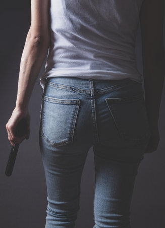 woman holding pistol on white backgroundの写真素材