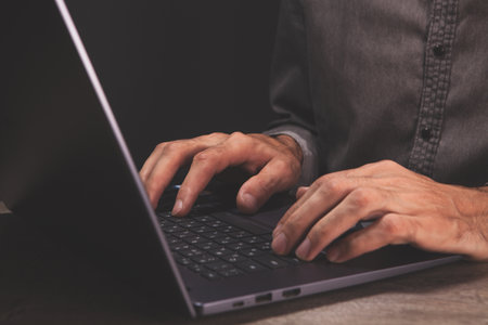 man typing on a laptop keyboard.の写真素材