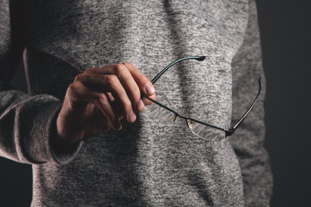 man holding eyeglasses..