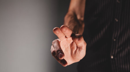 man in black shirt holding a hand