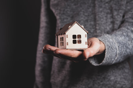 a man holding a house model.の写真素材