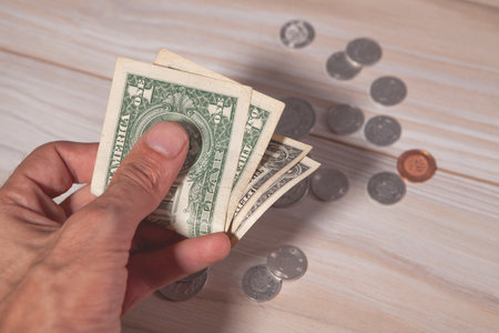 a hand holds a stack of dollars and one hundred dollar bills. concept of a business.の写真素材