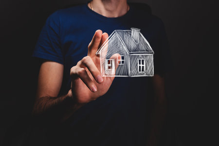 male hands holding house modelの写真素材