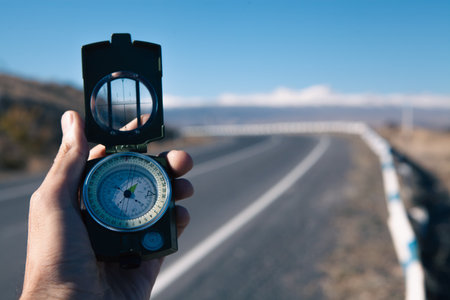 compass in hand on a background of mountainsの写真素材