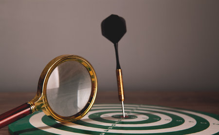 glass magnifying glass, target with dart,の写真素材