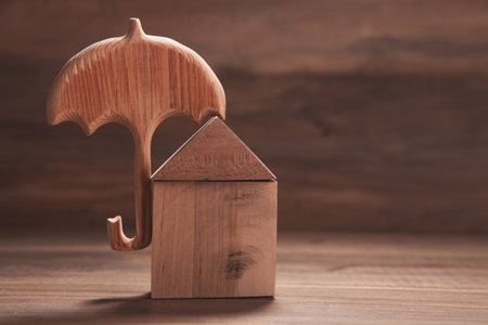 miniature model of a wooden house on a black background, real estate conceptの写真素材